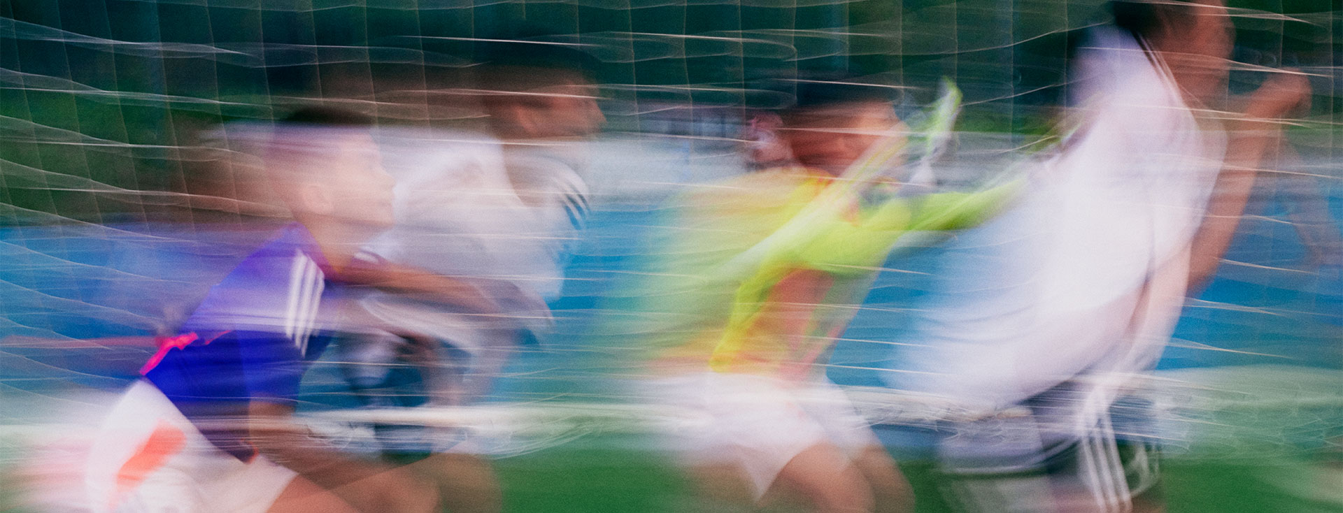 Boys playing soccer in front of a goal (Photo)