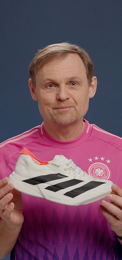 Bjørn Gulden, CEO (Photo) holding a new model of adidas training shoe in his hands, posing in a photoshoot.