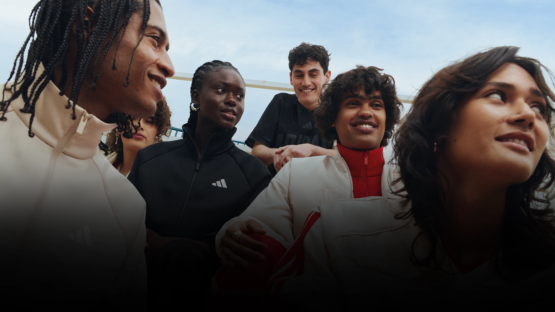 Group of young people wearing adidas outfits outdoors. (Photo)