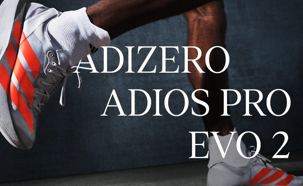Person wearing white adidas running shoes with red stripes while running, with the text “Adizero Adios Pro Evo 2.” (Photo)
