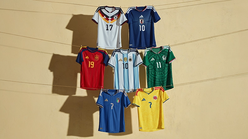 Several national football team jerseys from different countries hanging side by side on a wall, in various colors with different numbers. (Photo)