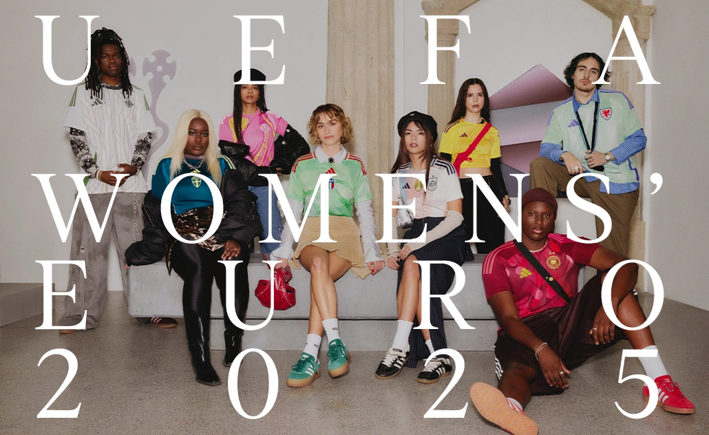 Group of eight people (women and men) wearing different football jerseys, sitting and standing indoors; large overlaid text reads “UEFA Women’s Euro 2025”. (Photo)